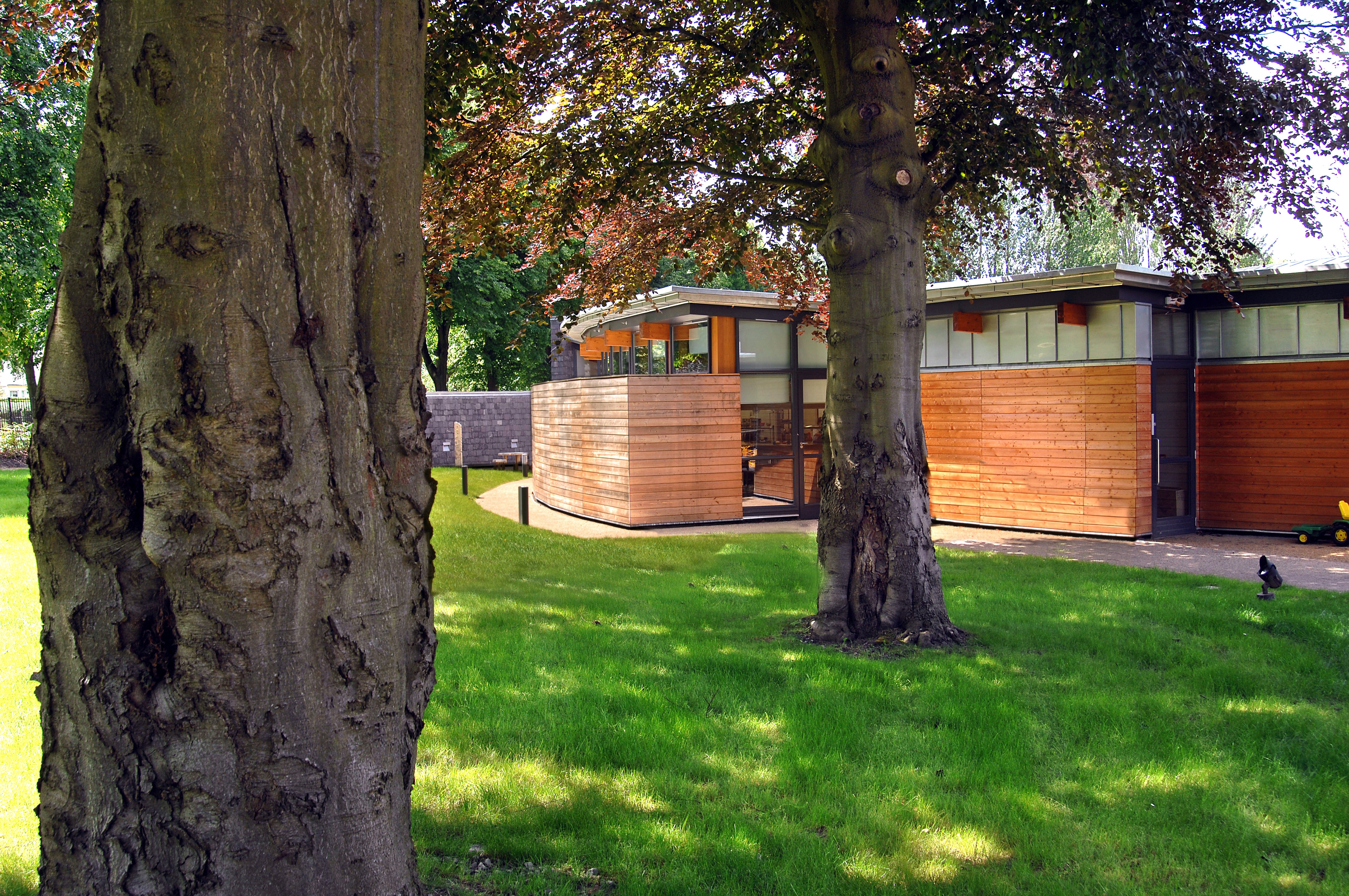 Exterior view of school showcasing two large trees that sit near the building