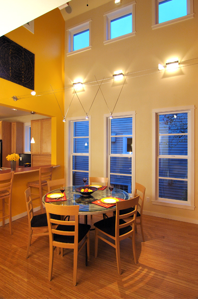 Three parallel windows that begin low to the floor in dining area