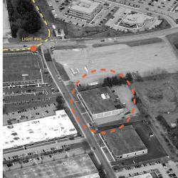 Aerial image of the original building including nearby light rail