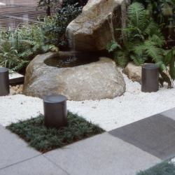 Meditation garden with a water feature, large rocks, and gravel base