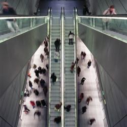 Passengers using escalators in a metro station